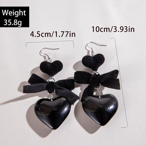 Detail view of black velvet bow and heart earrings with precise size and weight dimensions