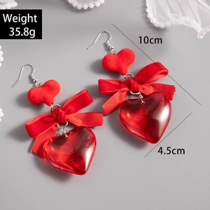 Detail showing red acrylic heart earrings with dimensions 10cm length and 4.5cm width