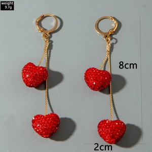 Detail view of red heart crystal earrings with gold lever-back and 8cm drop chains