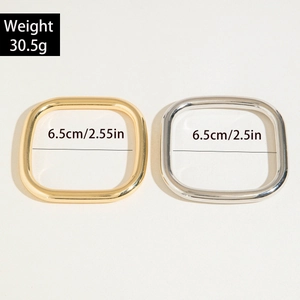 Detail of square gold and silver metal ring buckles with 6.5cm size and 30.5g weight