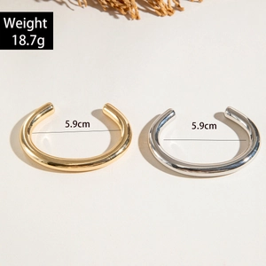 Minimalist gold and silver C-shaped open bangles with high-polished metal finish