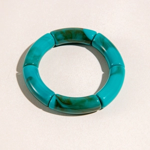 Detail shot of chunky lake green acrylic bracelet with unique marble texture and segments