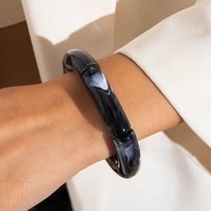 Close-up of leopard pattern acrylic tube bracelet with black and white marble texture