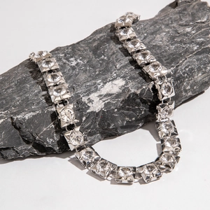 Macro detail of silver chunky chain necklace with square-cut cubic zirconia stones
