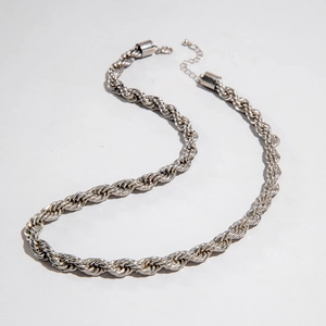 Macro shot of a chunky silver rope chain necklace with a secure lobster clasp detail