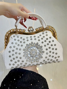 Macro view of white crocodile pattern evening bag with luxury crystal flower and rhinestone