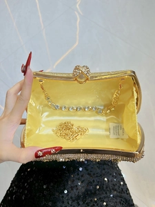 Sparkling gold evening clutch bag with rhinestone embellishments and dual metal chains
