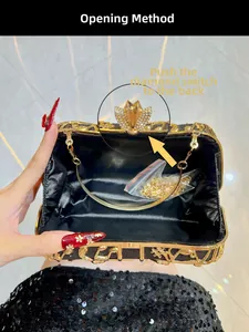 Détail du sac de soirée noir avec motifs ajourés dorés et fermoir en strass