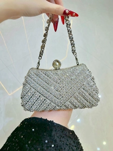 Detail of silver rhinestone evening clutch with pearl clasp and diamond lattice pattern