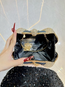 Luxury butterfly clutch bag with blue glitter and sparkling crystals, hand-held view