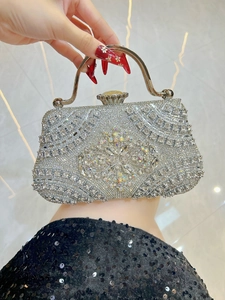 Detail of luxury evening clutch bag with sparkling crystals and floral gemstone patterns
