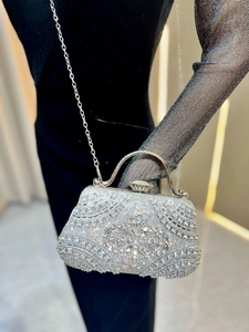 Detail of shimmering silver rhinestones and floral pattern on a luxury evening clutch bag