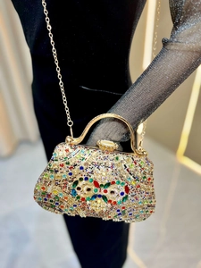 Detailed shot of luxury evening bag with multicolored rhinestones and a crystal bow accent