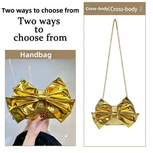 Detail of golden bow-shaped evening clutch bag with metallic texture and chain strap