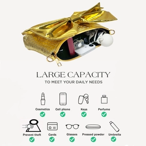 Detail of gold bow evening clutch showing spacious interior for phone and perfume