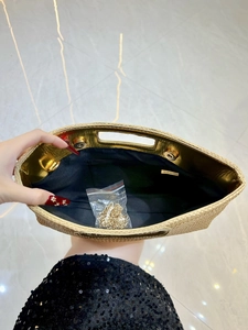 Beige straw woven clutch bag with gold lining, magnetic closure and detachable chain