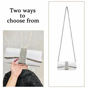 Detail of white evening clutch featuring rhinestone band and silver metal chain strap