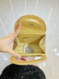 Golden snakeskin embossed handbag with yellow fabric lining and silver chain strap