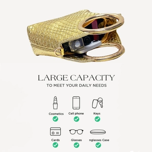 Detail view of large capacity golden woven handbag interior with round metal handles