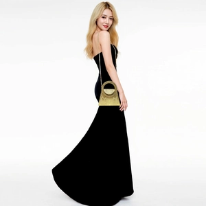 Detail of elegant gold evening bag with snake texture, metal handle and chain strap