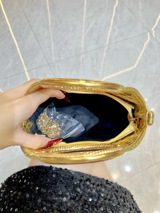Golden woven evening clutch bag with ring handles and chain strap for parties