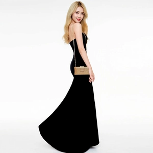 Elegant gold glitter evening clutch with chain strap styled with black velvet gown