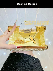 Detail of evening clutch with rhinestones, pearls and golden chain strap inside