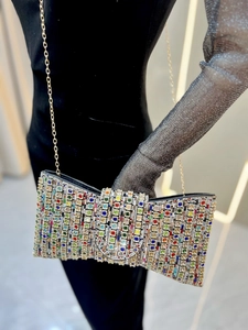 Rainbow rhinestone evening clutch bag with gold chain strap shown on mannequin