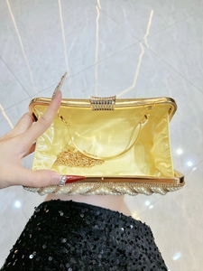 Luxury gold evening clutch bag with pearls and rhinestones shown with metal chain
