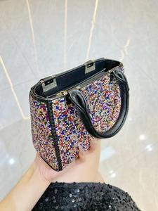 Elegant multi-color rhinestone handbag with black leather trim and silver metal clasp