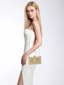 Detail shot of vintage evening clutch with intricate pearl beads and golden chain strap