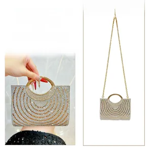 Detail of rhinestone evening clutch showing round metal handle and sparkling diamond pattern