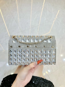Detail of silver rhinestone evening bag with luxury crystal mesh and metal studs