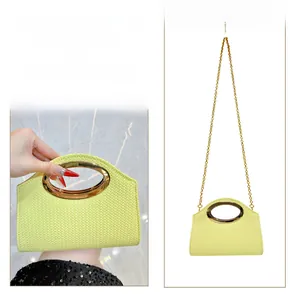 Detail of lemon yellow woven handbag with gold oval handle and chain strap options