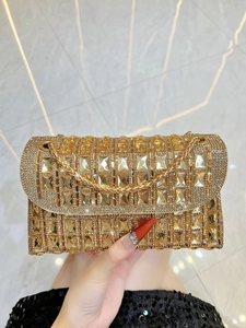 Detail of luxury gold evening bag with rectangular crystal embellishments and chain strap