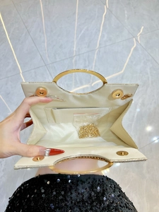Champagne gold evening clutch with rhinestone trim and round metal ring handle