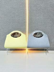 Fashion woven handbag with oval metal handle and chain strap in yellow and grey colors