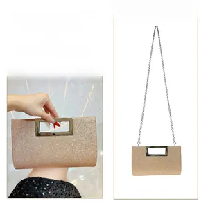 Champagne sequin clutch bag with silver handle showing handbag and cross-body styling