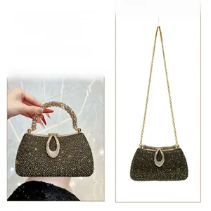 Detailed view of rhinestone clutch showing hand-held handle and crossbody chain strap