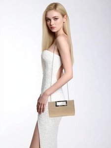 Detailed view of glittering gold evening clutch with silver chain strap on dress