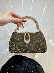 Macro shot of luxury evening clutch with gold rhinestones and water-drop diamond buckle