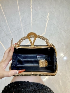 Luxurious black sequined evening clutch bag with sparkling rhinestone handle and gold chain