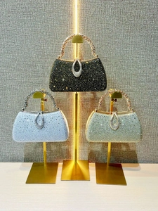 Sparkling rhinestone evening handbags in black silver and gold on display stands