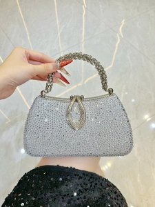 Detail of silver rhinestone evening bag with luxury crystal handle and drop lock