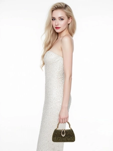 Detail of elegant black evening bag with gold rhinestones and crystal handle