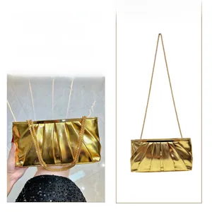 Detail of gold pleated evening bag showing clutch and cross-body styles with chain