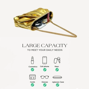 Detail view of gold pleated clutch showing interior capacity for phone and cosmetics