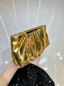 Luxurious gold pleated evening clutch bag with metallic finish and thin chain strap