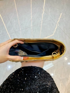 Golden metallic pleated evening clutch bag with chain strap and interior pocket