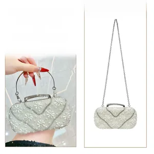 Elegant ivory evening clutch with floral pearl patterns and crystal handbag handle
